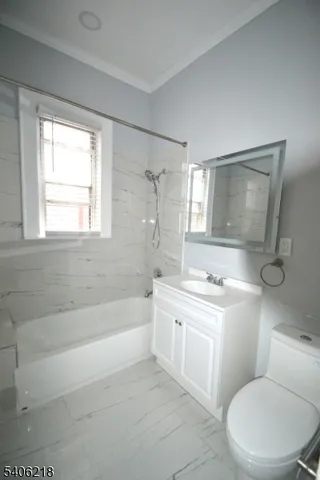 a bathroom with a granite countertop toilet a sink and bathtub