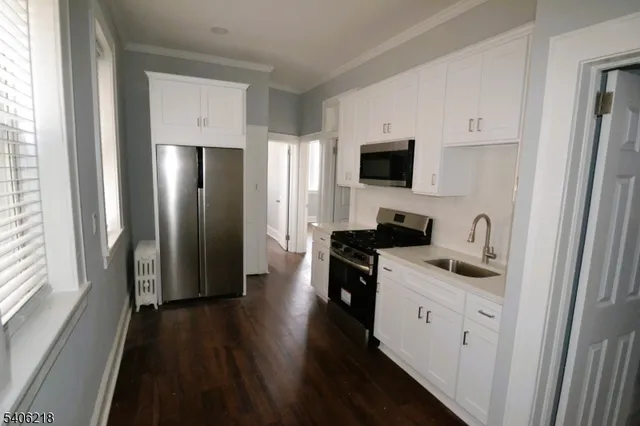 a kitchen with stainless steel appliances a refrigerator stove and sink