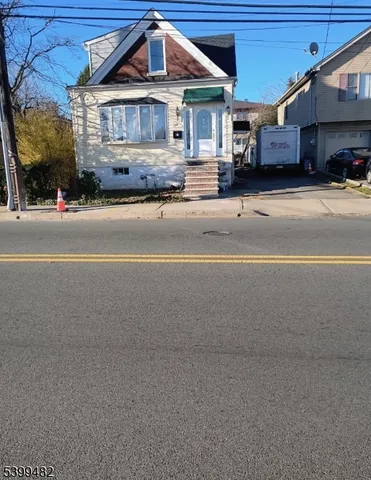 a front view of a house with a street