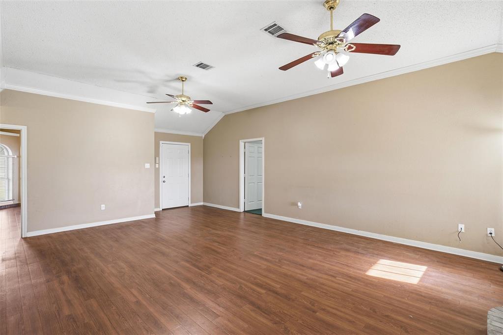 155 Rabajo Road China Spring, TX 76633 - Photo 6 of 40 an empty room with wooden floor and a ceiling fan