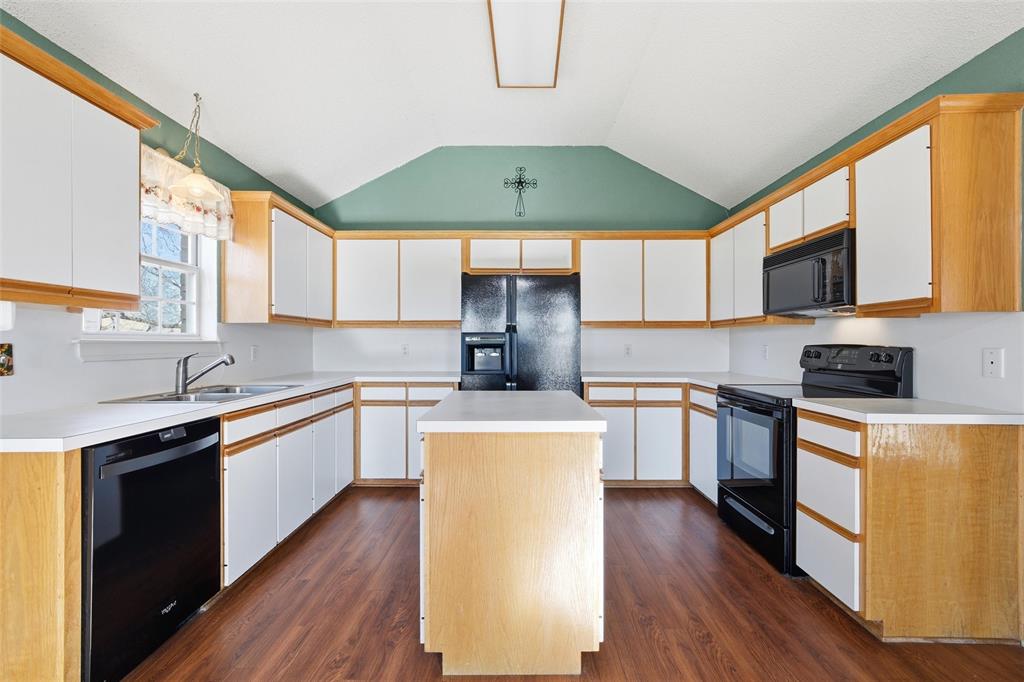 155 Rabajo Road China Spring, TX 76633 - Photo 9 of 40 a kitchen with stainless steel appliances a microwave a stove a sink dishwasher a refrigerator white cabinets and wooden floor