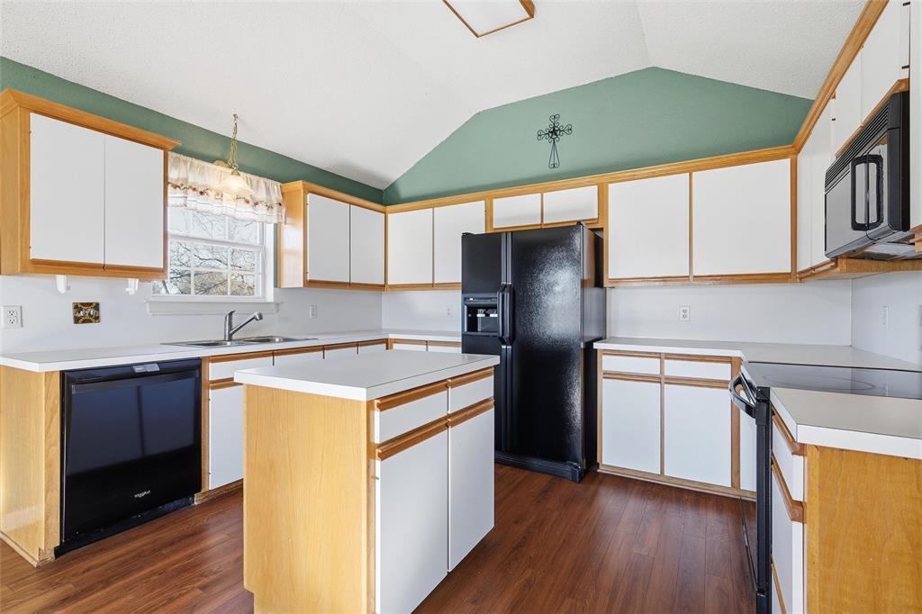155 Rabajo Road China Spring, TX 76633 - Photo 10 of 40 a kitchen with stainless steel appliances granite countertop a refrigerator a sink dishwasher a stove and white countertops with wooden floor