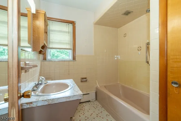 a bathroom with a sink a bathtub and a shower