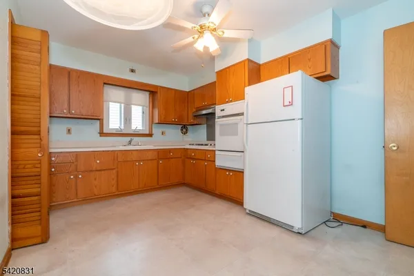a kitchen with cabinets a sink and appliances