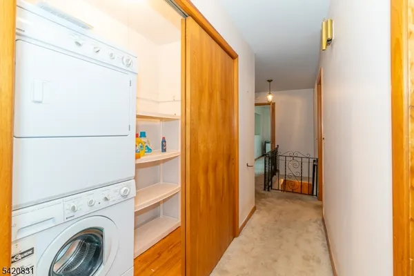 a view of a hallway with washer and dryer