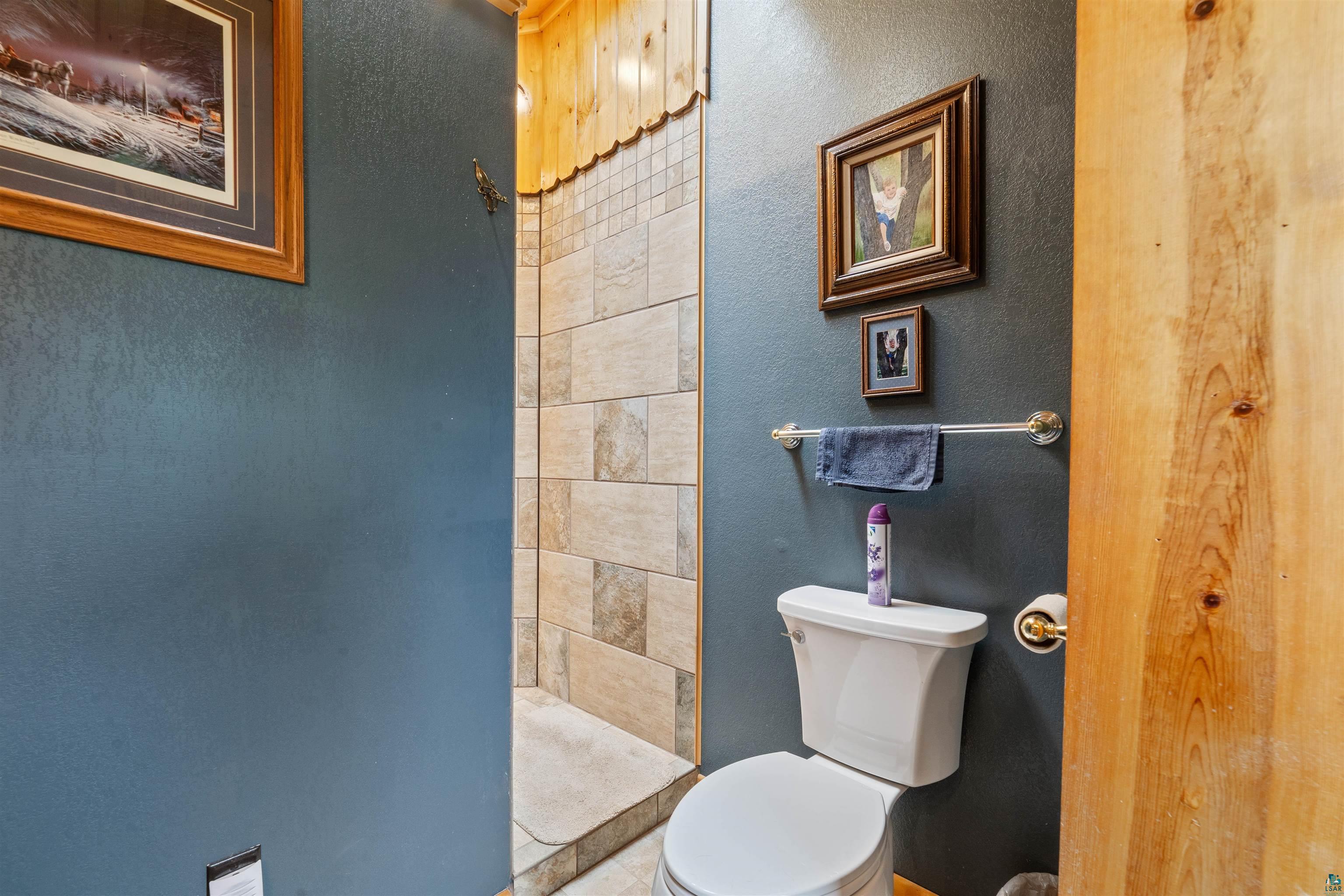 11911 East Rowe Road Lake Nebagamon, WI 54849 - Photo 43 of 61 Walk-in shower with natural stone tile surround and wood-finish ceiling accent
