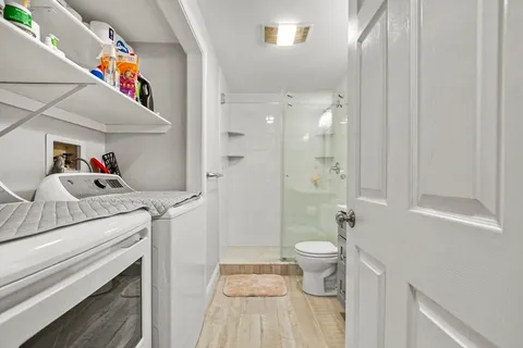 a bathroom with a sink a toilet and shower