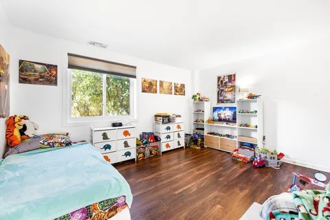 a bed room with furniture and a wooden floor
