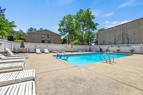 a view of a patio with a table and chairs under an umbrella