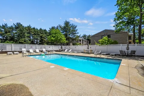 a swimming pool with outdoor seating and yard