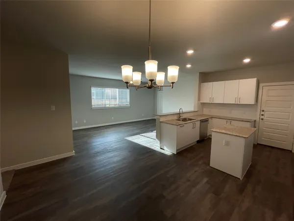 a kitchen with a sink and chandelier