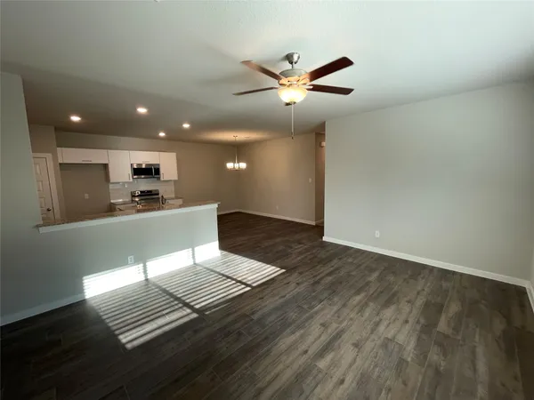 a view of kitchen with sink refrigerator and microwave