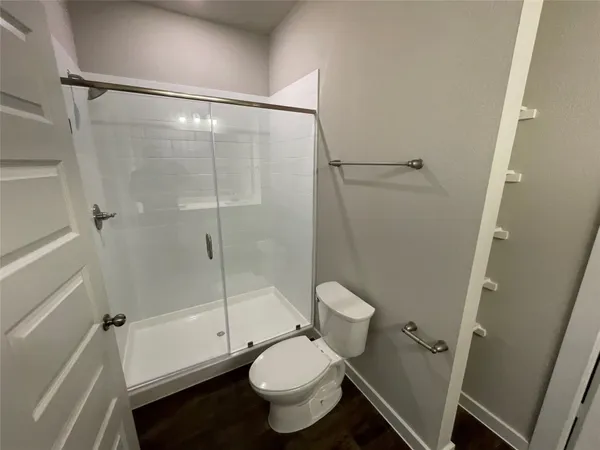 a bathroom with a toilet and a shower