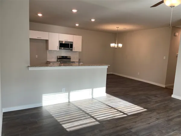 a kitchen with stainless steel appliances a refrigerator and a stove top oven
