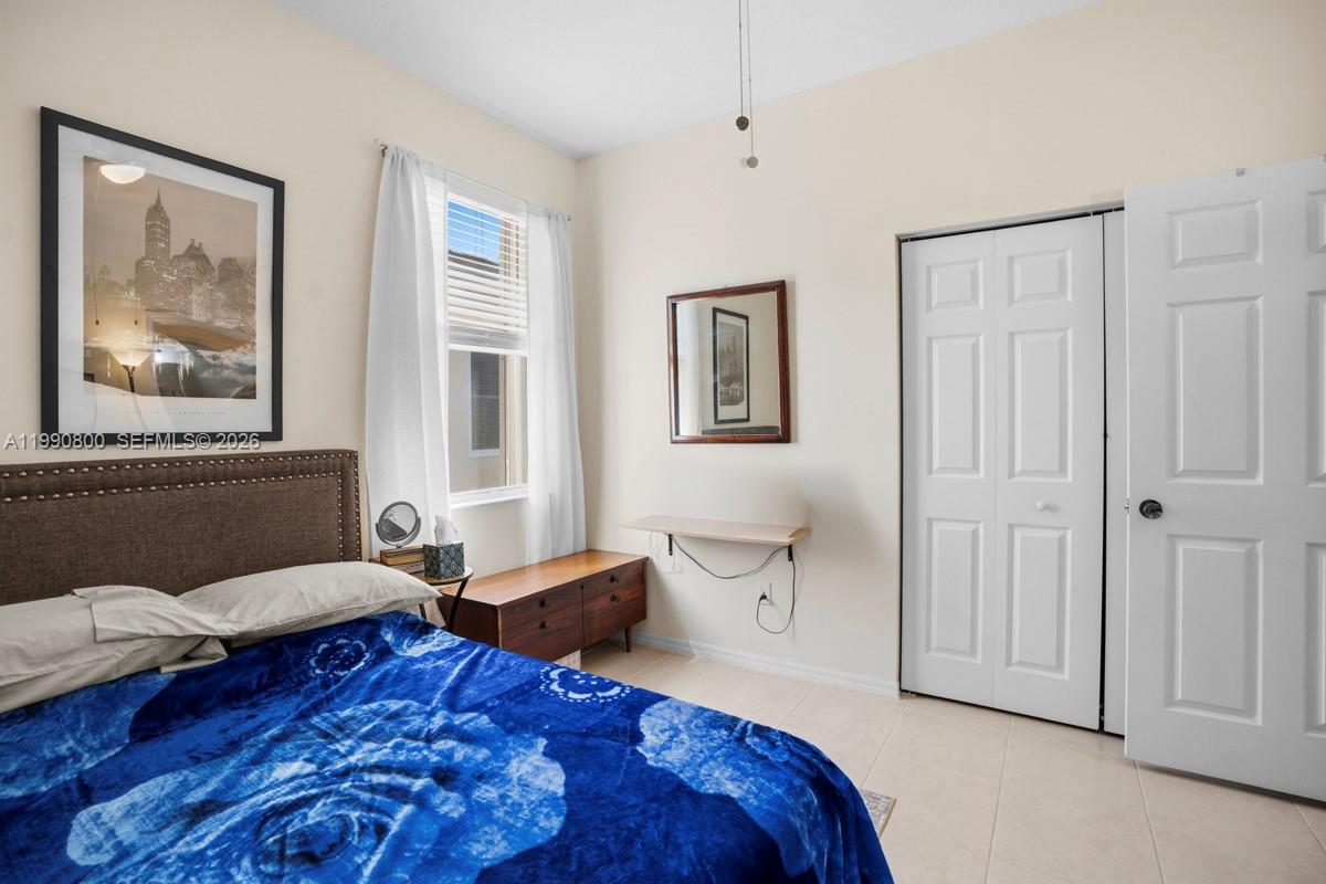 337 Southwest Maclay Way Port St. Lucie, FL 34986 - Photo 24 of 52 a spacious bedroom with a bed and a couch