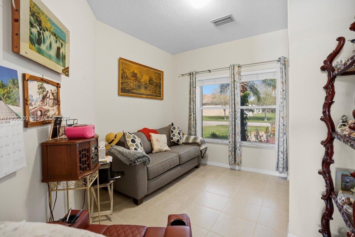 337 Southwest Maclay Way Port St. Lucie, FL 34986 - Photo 26 of 52 a living room with furniture and a window