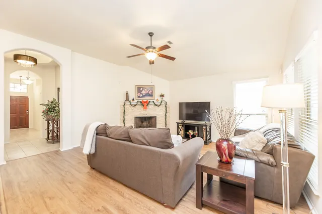 a living room with furniture fireplace and flat screen tv