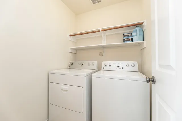 a bedroom with a bed chandelier and a window