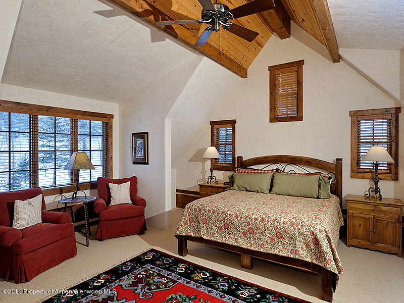 19 Arbaney Ranch Road Basalt, CO 81621 - Photo 9 of 20 a bedroom with a bed couch and a large window