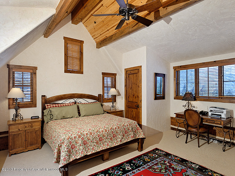 19 Arbaney Ranch Road Basalt, CO 81621 - Photo 10 of 20 a bedroom with a bed and wooden floor