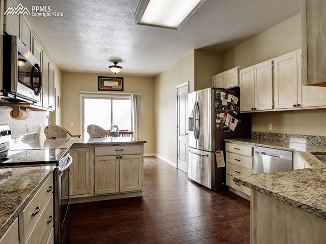 11350 Calgary Road Peyton, CO 80831 - Photo 8 of 29 Lots of counter space complete with breakfast bar.