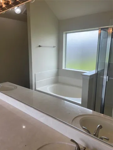 a bathroom with a bathtub and a shower