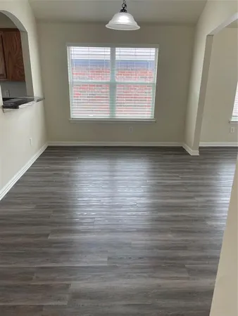 a view of room with window and wooden floor