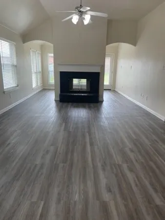 wooden floor in an empty room with a fireplace