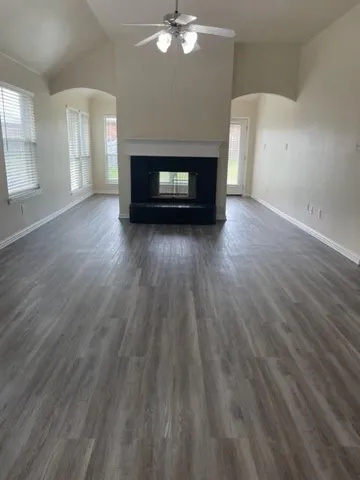 wooden floor in an empty room with a fireplace