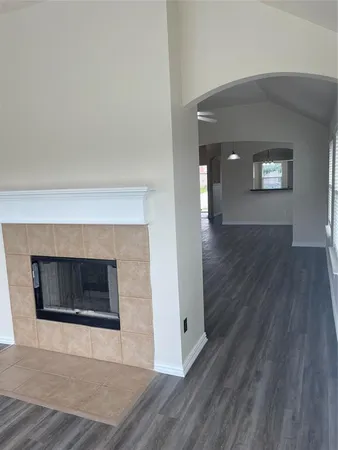 a view of an empty room and wooden floor