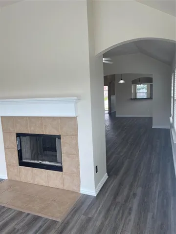 a view of an empty room and wooden floor