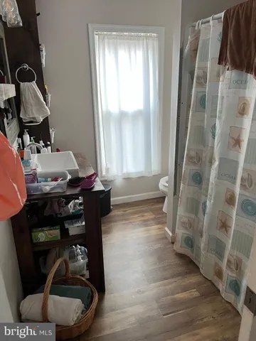 a room with wooden floor and glass door