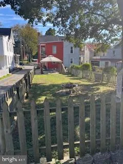 a view of a house with backyard fountain and sitting area