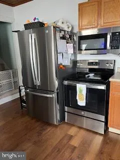 a kitchen with stainless steel appliances granite countertop a stove microwave and refrigerator