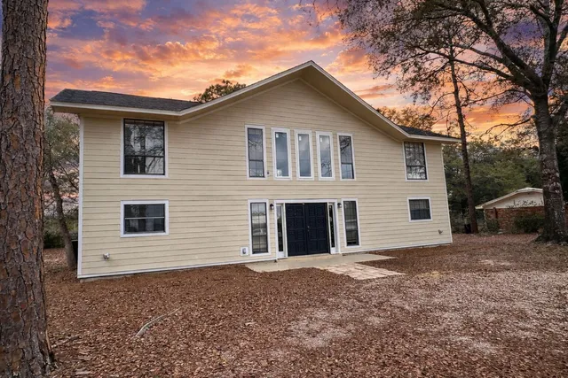 a view of a house with a yard and garage
