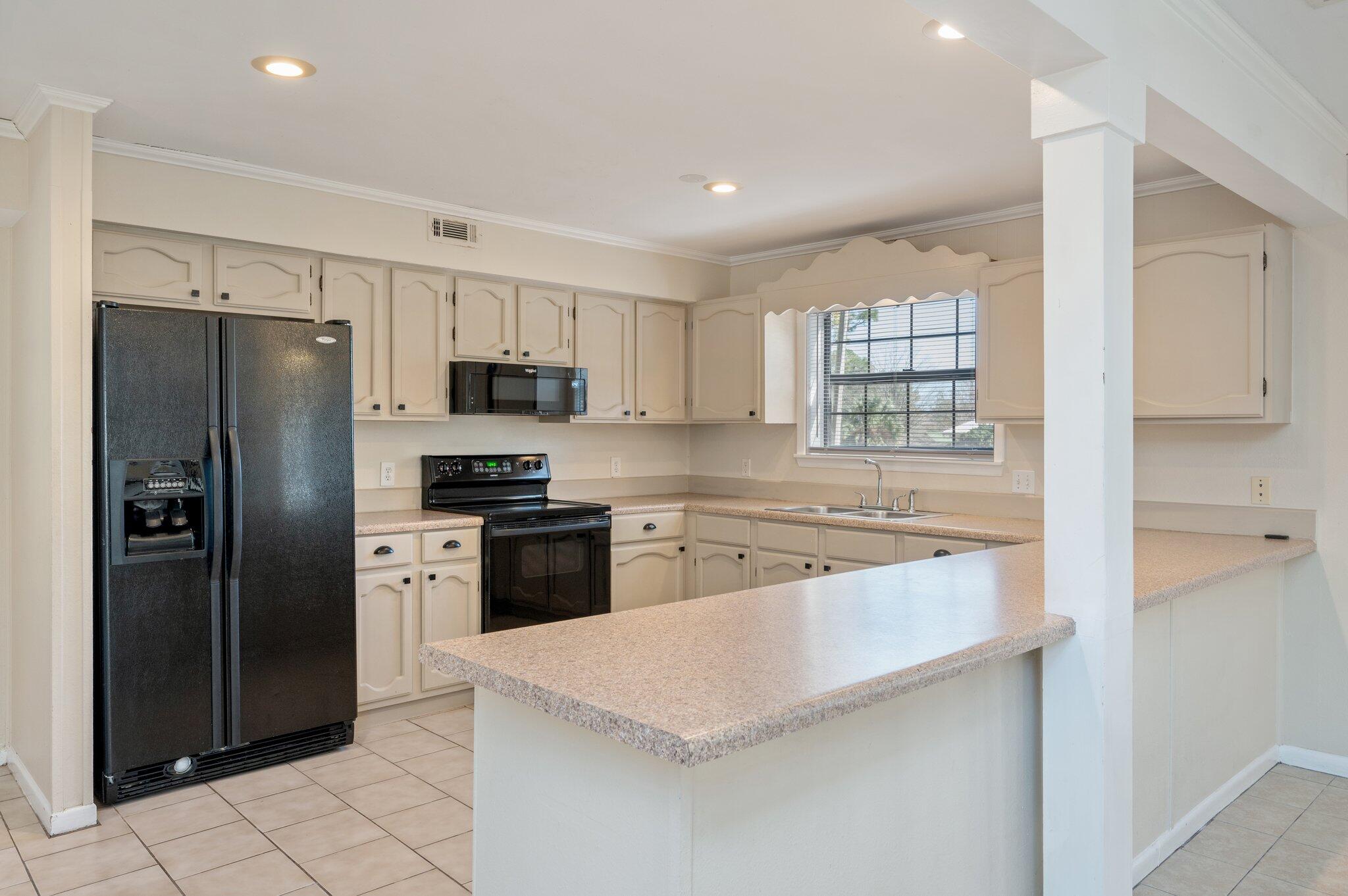 770 Lakeview Drive DeFuniak Springs, FL 32433 - Photo 8 of 32 a kitchen with stainless steel appliances granite countertop a refrigerator stove top oven and sink