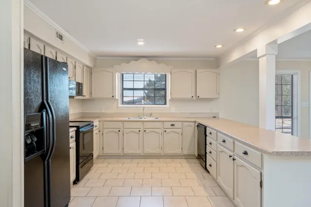 a kitchen with appliances a sink and cabinets