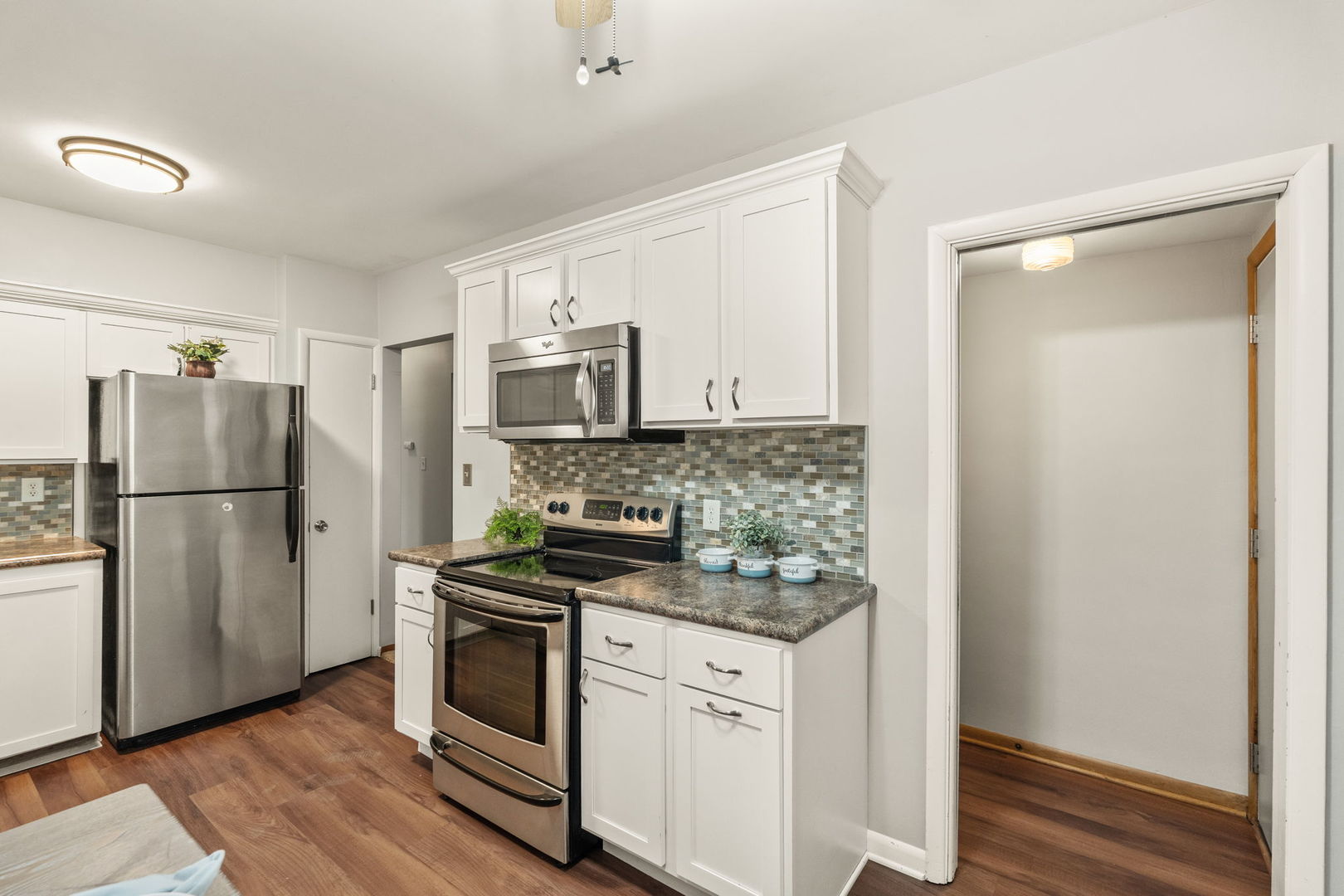 3103 15th Street A Moline, IL 61265 - Photo 12 of 33 a kitchen with a refrigerator stove and microwave