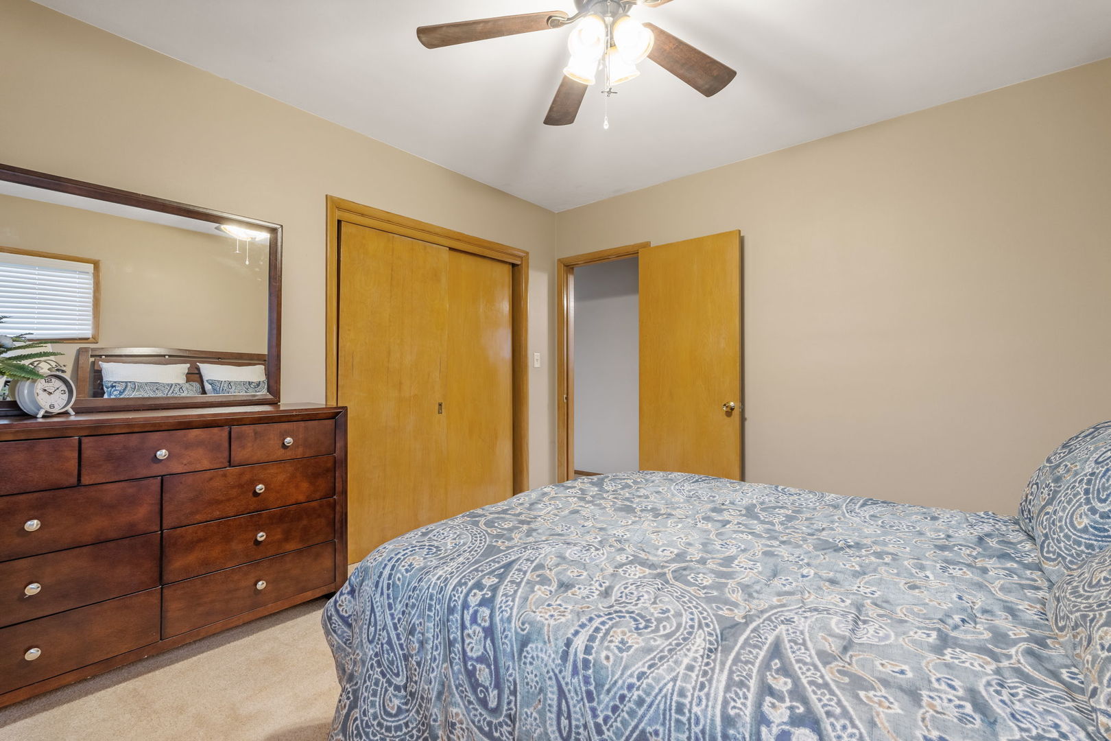 3103 15th Street A Moline, IL 61265 - Photo 14 of 33 a bedroom with a bed and a mirror on dresser