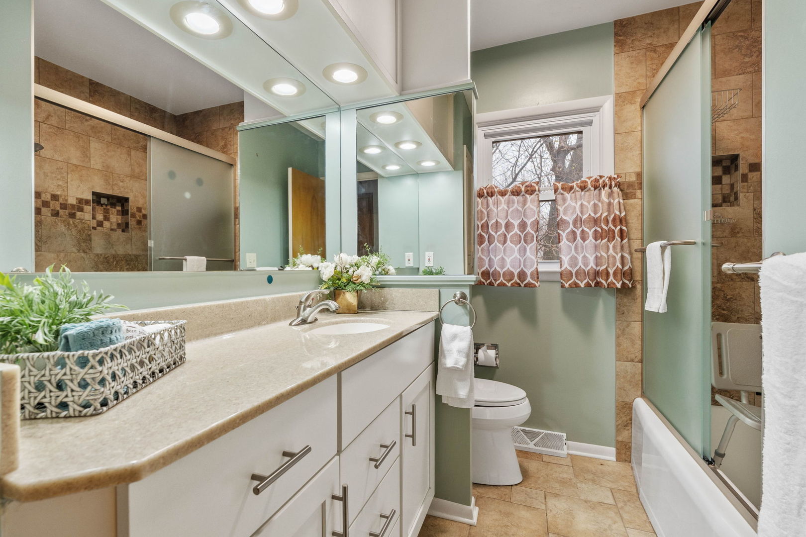 3103 15th Street A Moline, IL 61265 - Photo 15 of 33 a bathroom with a granite countertop sink a toilet a mirror and shower