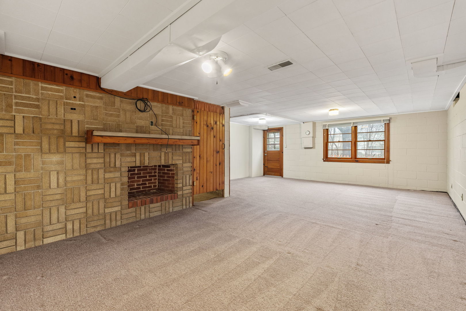3103 15th Street A Moline, IL 61265 - Photo 19 of 33 a view of an empty room with a fireplace and a window