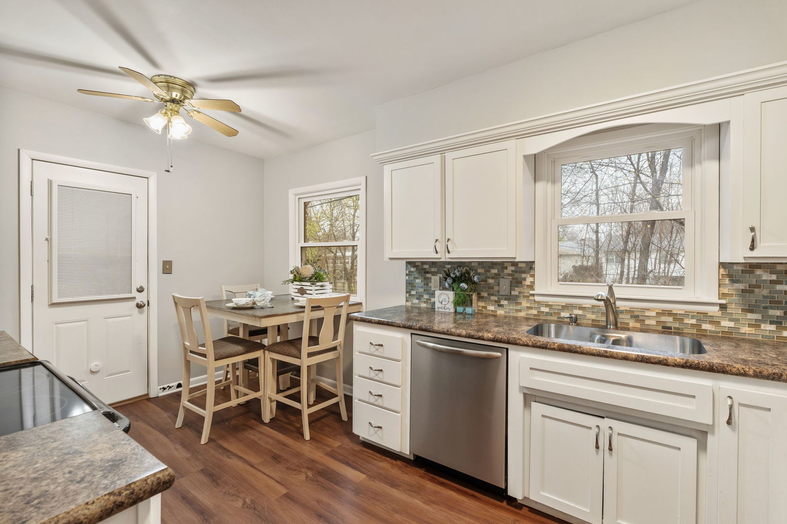 3103 15th Street A Moline, IL 61265 - Photo 7 of 33 a kitchen with a table chairs sink and cabinets