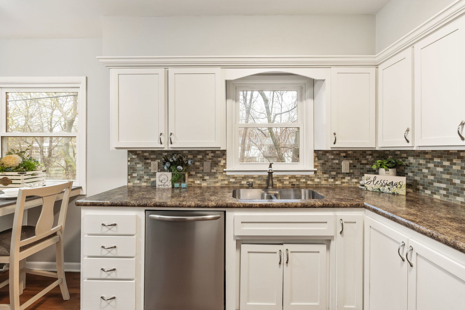 3103 15th Street A Moline, IL 61265 - Photo 8 of 33 a kitchen with granite countertop a sink window and cabinets