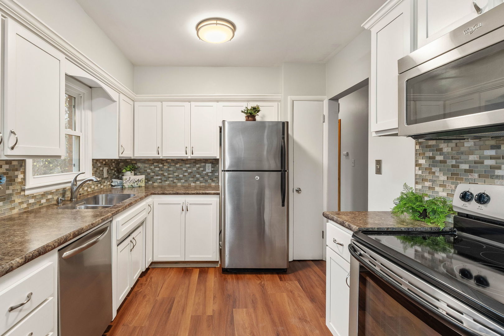 3103 15th Street A Moline, IL 61265 - Photo 9 of 33 a kitchen with granite countertop stainless steel appliances a refrigerator sink and stove