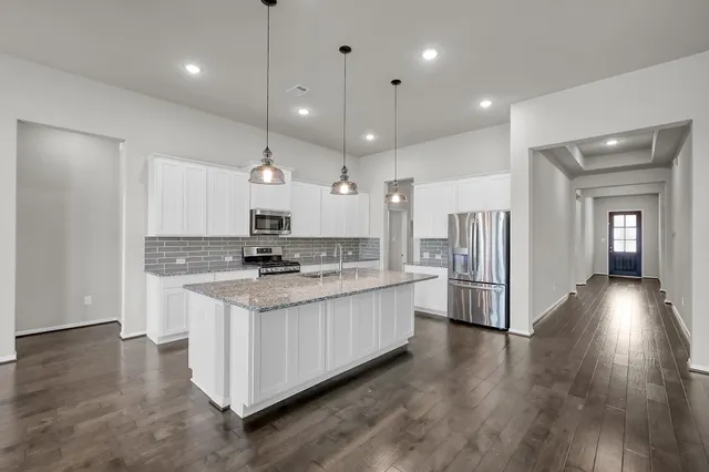 a large kitchen with stainless steel appliances kitchen island a large island in the center
