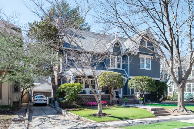 a view of building with lot of trees and plants