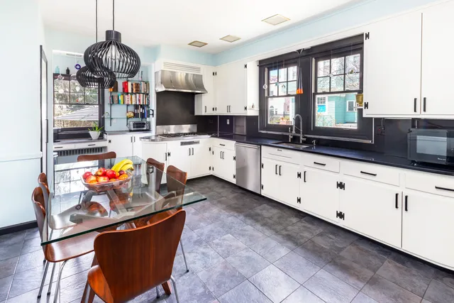 a kitchen with stainless steel appliances granite countertop a sink stove and cabinets