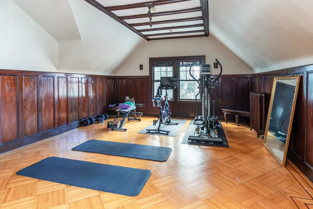 a room with gym equipment and a large window