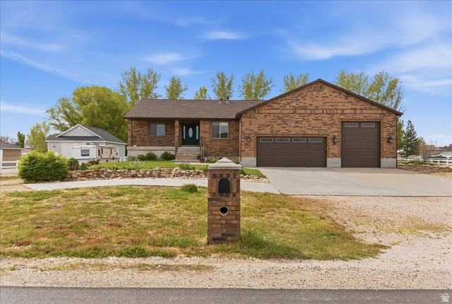 6237 West 4600th Street South Hooper, UT 84315 - Photo 1 of 48 Single story home with concrete driveway, an attached garage, a front yard, brick siding, and a shingled roof