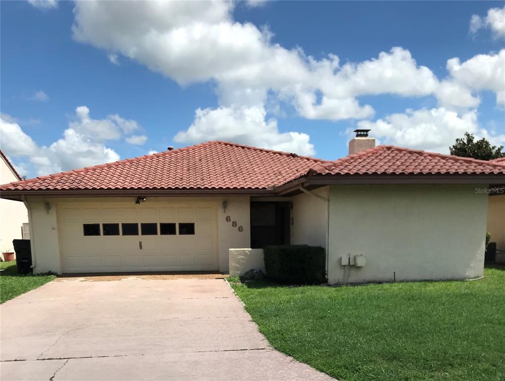 686 Augusta Road Winter Haven, FL 33884 - Photo 1 of 1 a backyard of a house with table and chairs